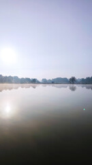 Fishing lake in the foggy morning