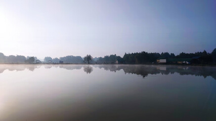 Fishing lake in the foggy morning