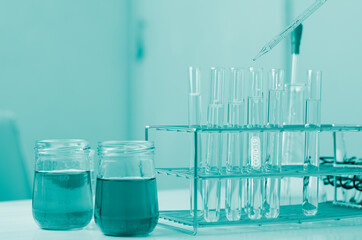 Pipette dropping a sample into a test tube and science experiments ,Laboratory glassware containing chemical liquid,