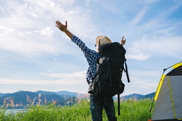 Male tourist on top mountain open arm summer freedom on vacation travel concept.