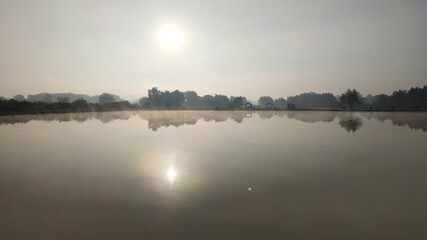 Fishing lake in the foggy morning