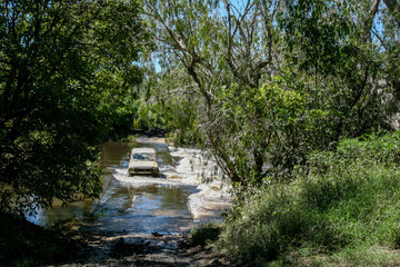 Fototapeta na wymiar Water crossing to a free Campground in northern Queensland with a 4x4, Australia