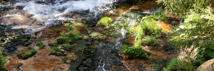 Wonderful panoramic landscape with moss and stones in the mountain river. Natural panoramic background