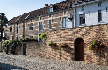 Fototapeta na wymiar Restored houses at the Begijnhof or Beguinage in the streets of Tongeren, the oldest town in Belgium
