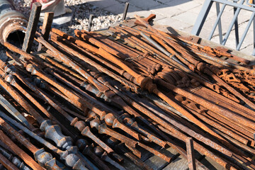 Used rusty metal bars for a fence offered for sale at an antique market in Tongeren, Belgium