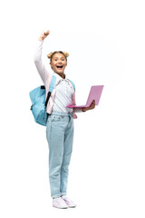 Excited schoolkid showing yes gesture while holding laptop on white background