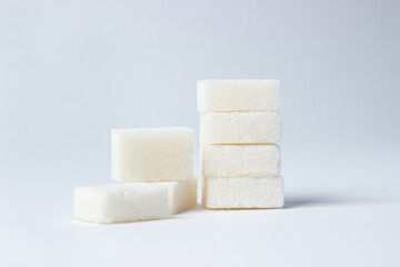 Refined sugar on a white background. White sugar cubes.