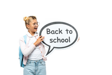 Schoolchild with backpack holding speech bubble with back to school lettering isolated on white