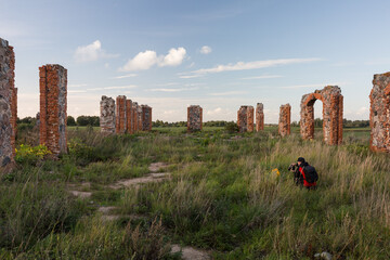 City Smiltene, Latvia.Old brick stonehenge and photographer.
