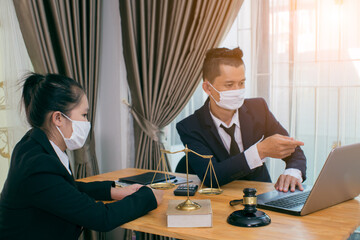 Male lawyer or judge wearing  protective mask on the consult having team meeting with client, Law and Legal services concept