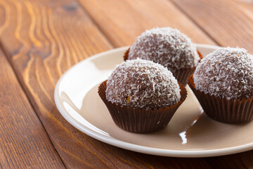 Chocolate balls in coconut shavings close up