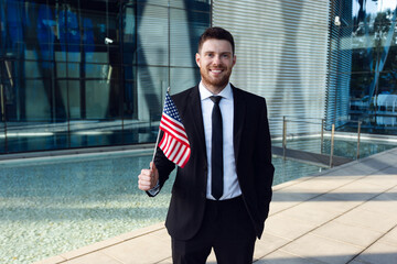 Businessman Standing with USA Flag in Hands. Businessman with American Flag in Business Center
