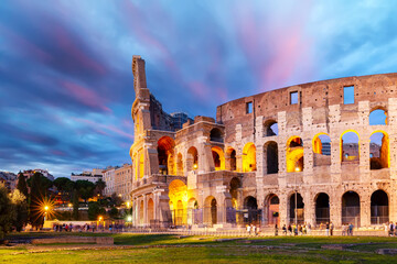Fototapeta na wymiar The Colosseum in Rome, Italy at colorful sunset twilight. The world famous colosseum landmark in Rome.