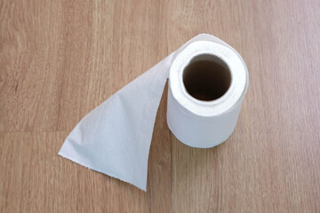 Toilet paper on the wooden table background.