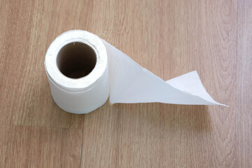 Toilet paper on the wooden table background.