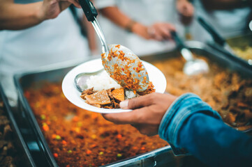Homeless receive food from volunteers : concept of food donation