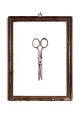 old and used scissors in wooden frame isolated on white 