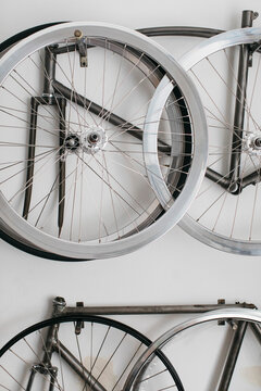 Bicycle rims and frames hanging on wall
