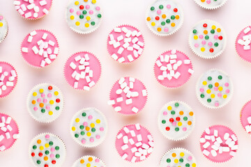 Colorful cupcakes on a white background.