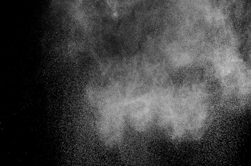 Freeze motion of white particles on black background. Powder explosion. Abstract dust overlay...