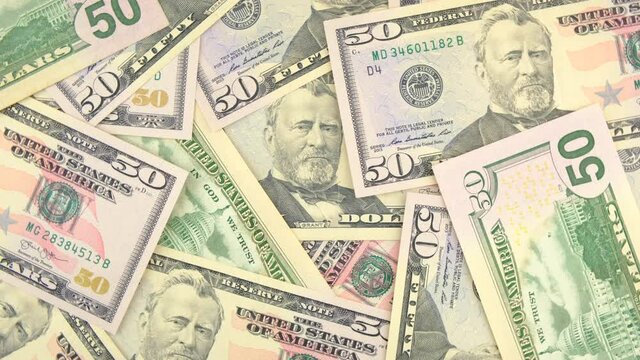 Dollar banknotes. 50 American dollars banknotes turning background.