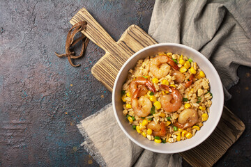 A traditional dish of Asian cuisine. Rice with shrimps, green onion and yellow corn