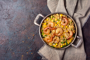 A traditional dish of Asian cuisine. Rice with shrimps, green onion and yellow corn