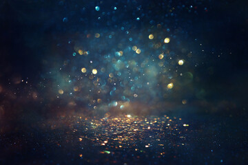 Fototapeta background of abstract glitter lights. gold, blue and black. de focused obraz