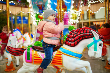 Adorable toddler girl on Christmas market in Paris