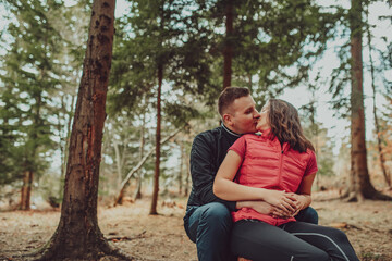 Young couple kissing in forest