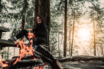 Fototapeta na wymiar young woman enjoying nature, picnicking in nature, walking in the forest enjoying the sunset