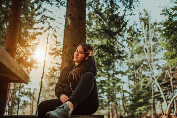 young woman enjoying nature, picnicking in nature, walking in the forest enjoying the sunset