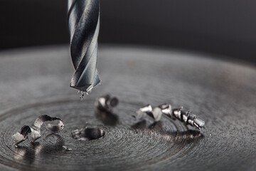 metal drill bit make holes in steel billet on industrial drilling machine. Metal work industry....