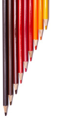 multi-colored wooden pencils in red shades on a white isolated background, autumn colors, mock up, vertical.