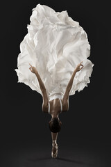 Ballerina Graceful Jump in White Silk Dress, Ballet Dancer Pointe Shoes in Fluttering Cloth, Black Background