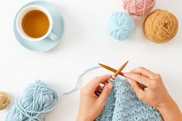 Woman hands knitting hat with needles and yarn