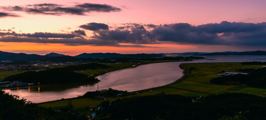 Beautiful, evening sky during sunset looms over the Imjingang River running through the rural landscape of Gimpo, South Korea. Imjingang seperates South Korea from the DMZ. 