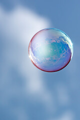 Reflection of houses and clouds in a floating bubble