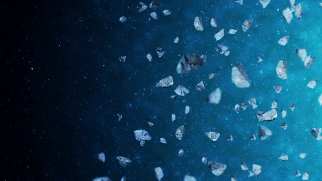 Flying many asteroids in deep space background. Broken splash explosion. The starry sky. 3D animation of meteorites rotating. Loop animation.