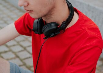 Photo of a guy with headphones on his neck