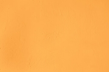 Saturated orange pastel colored low contrast Concrete textured background with roughness and irregularities. 2021, 2022 color trend.
