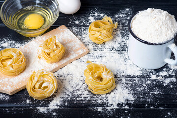 Tagliatelle cooking on a black table