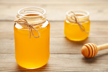 Jars of honey on grey wooden table
