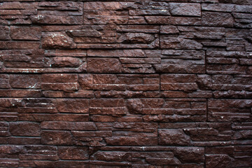 Dark brown vintage texture of a wall made of stones