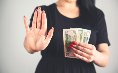 young woman hand stop sign in money