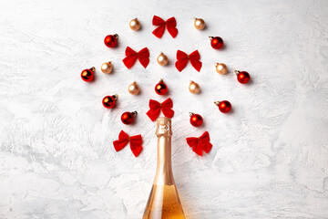 Flat lay composition with gold champagne bottle and Christmas balls
