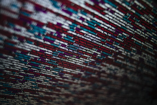 Closeup shot of a screen with HTML JavaScript source code for web page development data