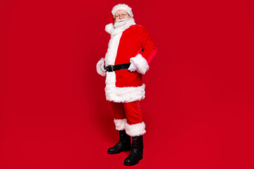 Full length body size profile side view of his he nice attractive handsome fat cheery Santa wearing winter season look outfit newyear occasion isolated bright vivid shine vibrant red color background