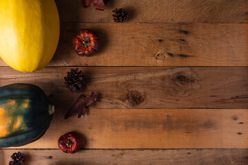 Thanksgiving Day. Traditional holiday. Autumn composition with dry leaves and pumpkins on a wooden table. View from above. Copy space