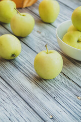 green apples on a light wooden background